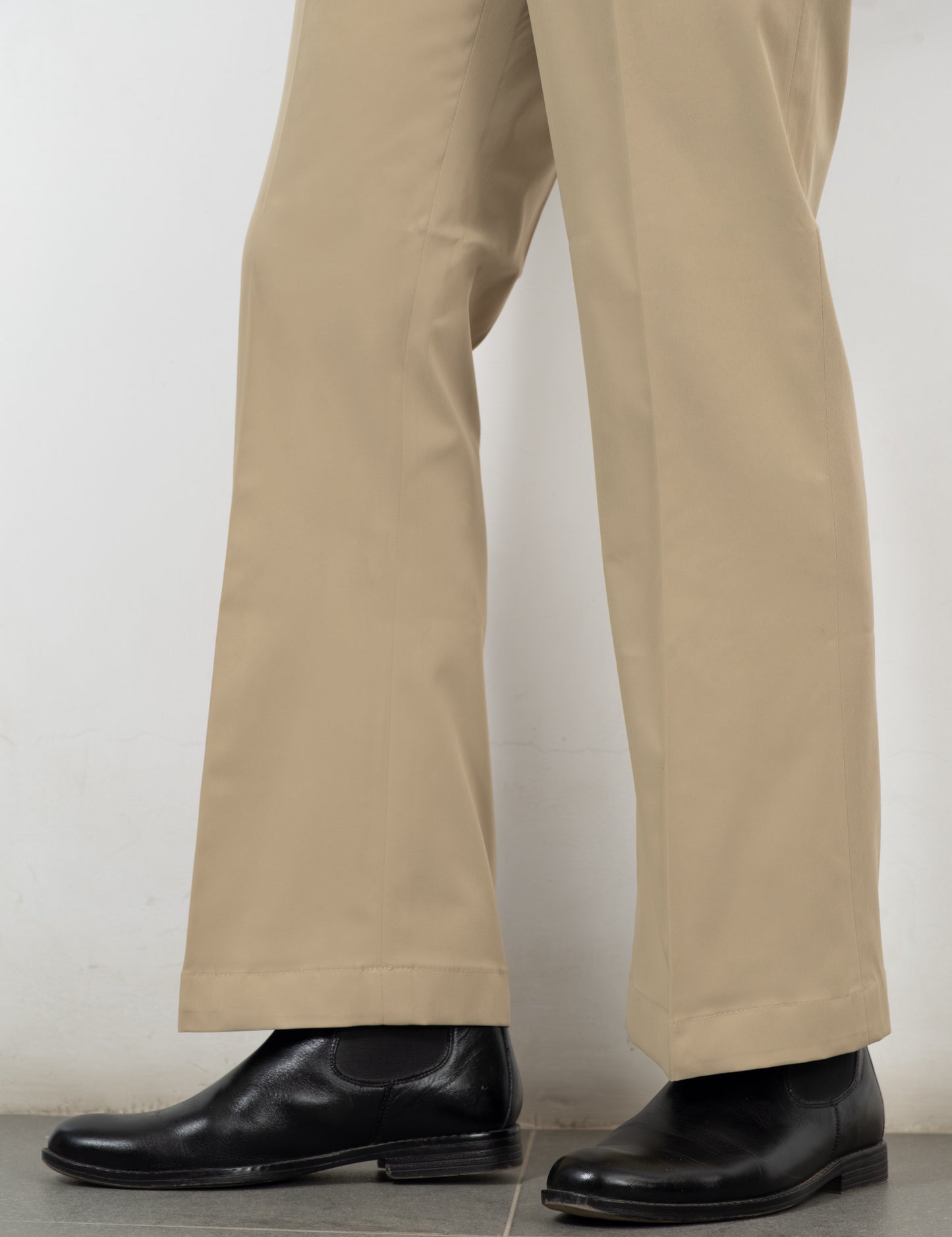Side adjuster and double pleat detail on the Sandro beige flared trousers from Drip Club