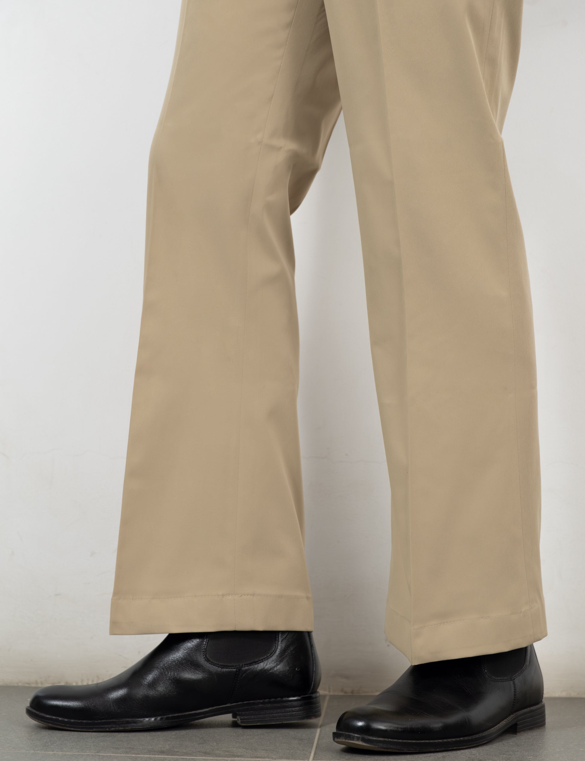 Side adjuster and double pleat detail on the Sandro beige flared trousers from Drip Club
